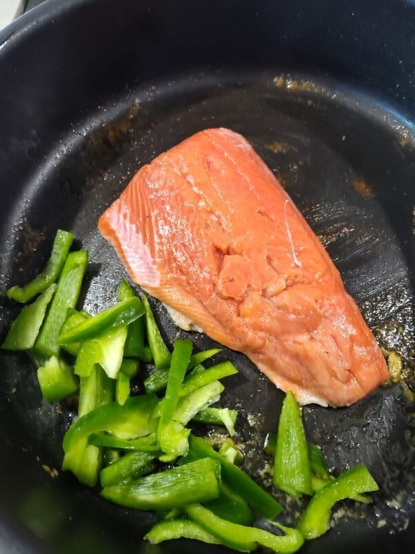 Add the bell pepper and garlic and cook to the side of the salmon dish