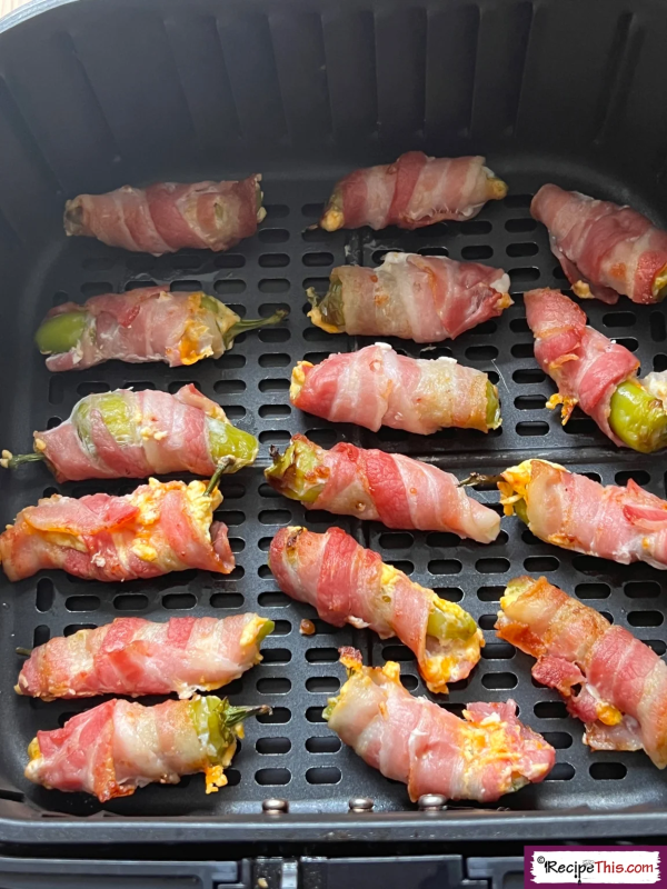 Calling all bacon lovers these air fryer bacon wrapped jalapeno poppers are going to become your new favourite appetizer and so fast to cook in the air fryer.  This low carb crispy bacon wrapped version of classic jalapeno poppers are perfect for prepping ahead of time and make the perfect game day or party snack.